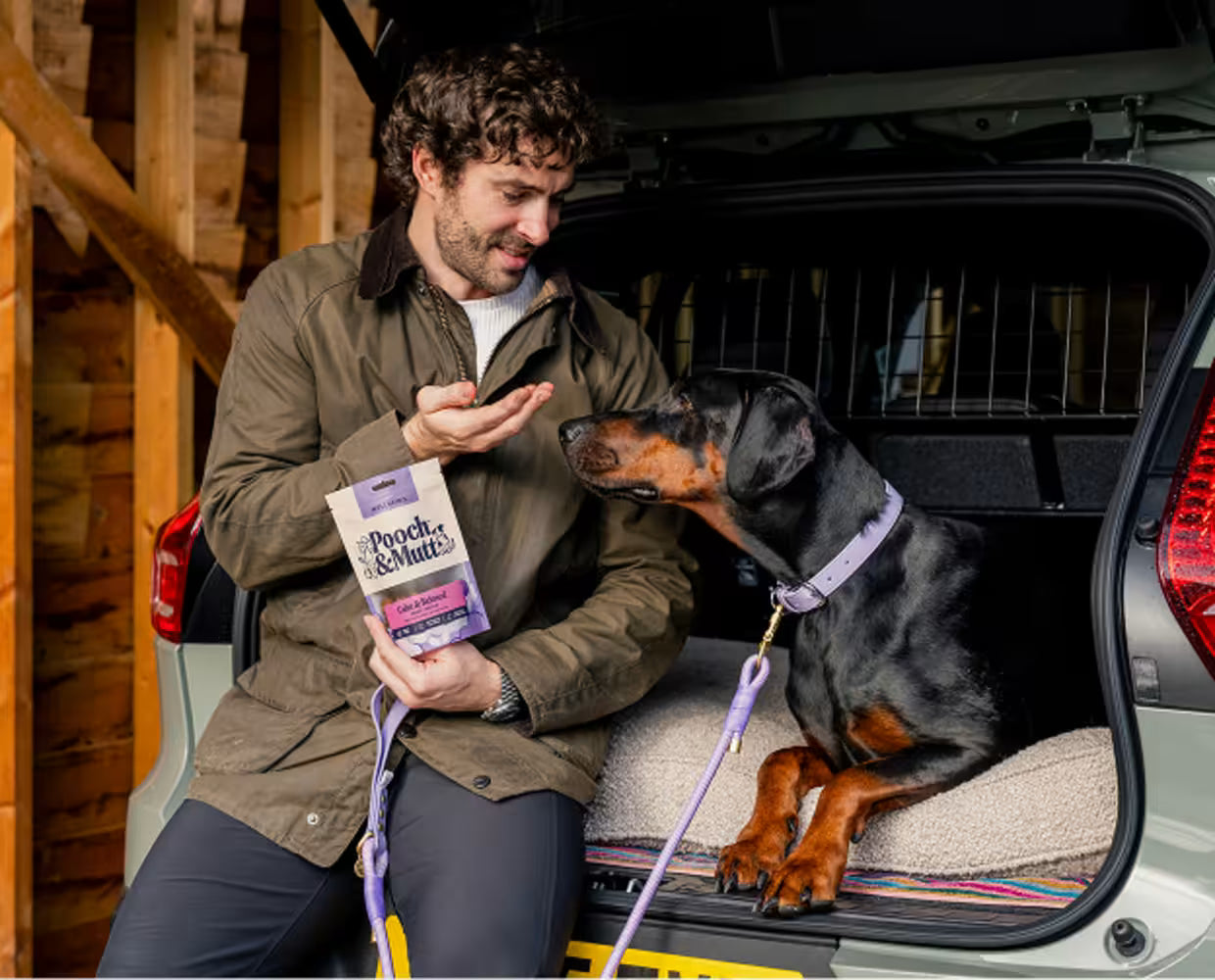 Pooch & Mutt dog subscription box featuring a happy dog and the "Take Their Lead" branding on the packaging.